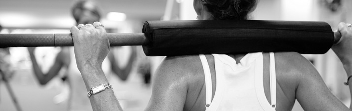 Fitness banner showing a lady exercising with a barbell